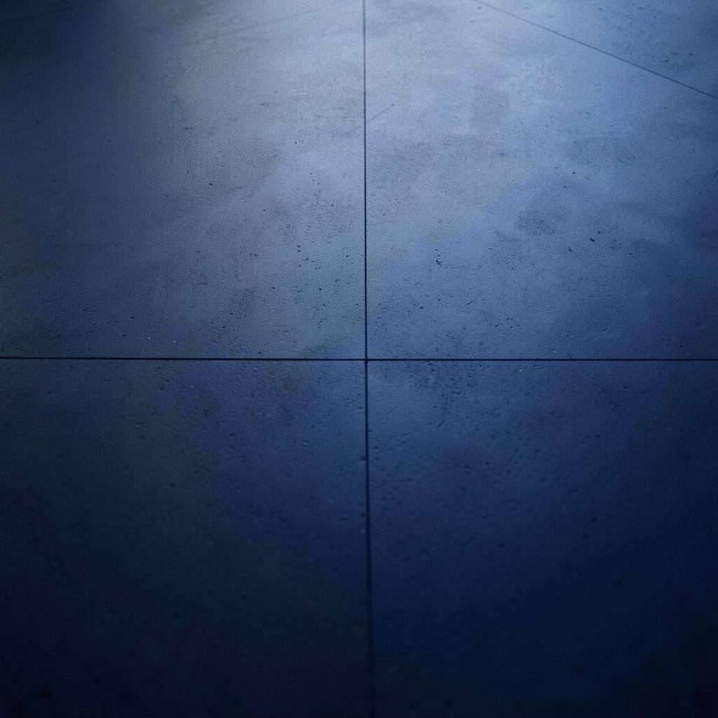 Dark gray rubber flooring tiles with a textured slip-resistant surface